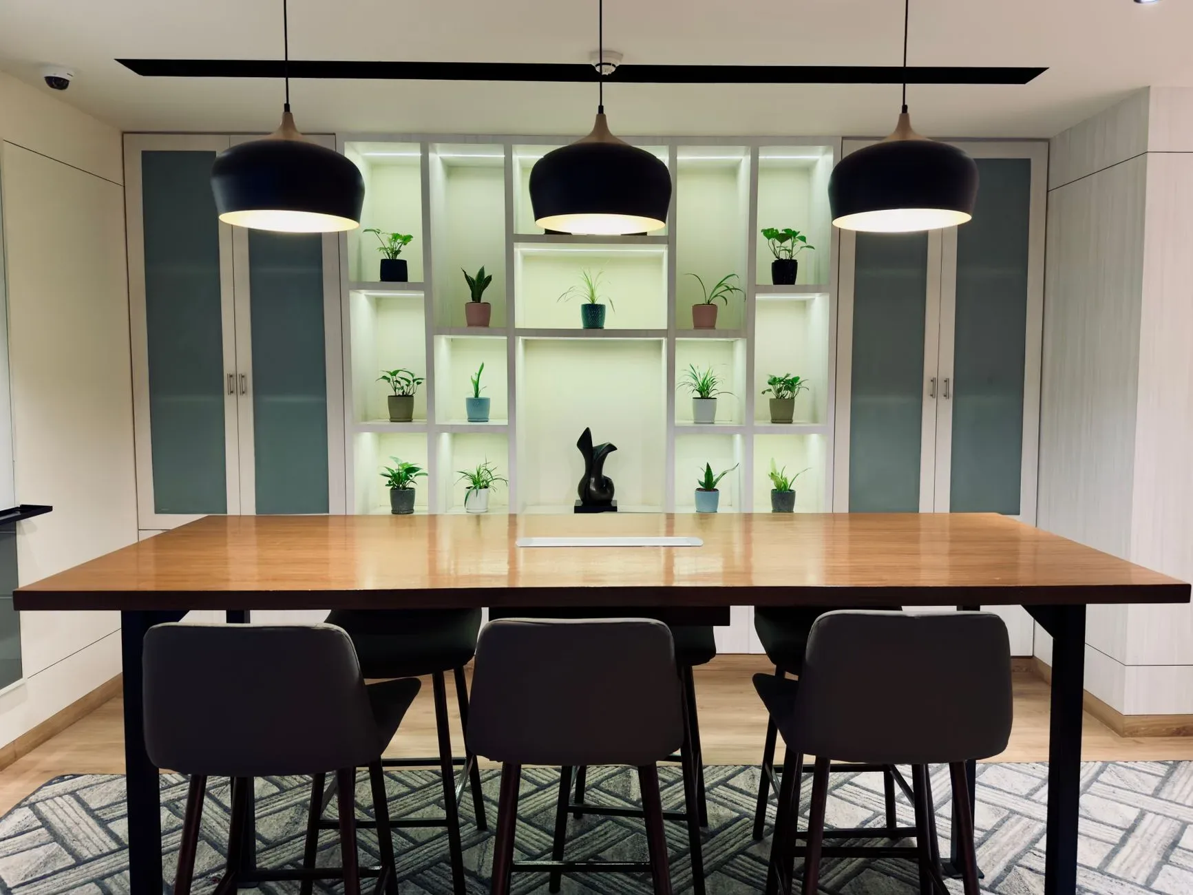 A chic dining area featuring minimalist design and modern lighting