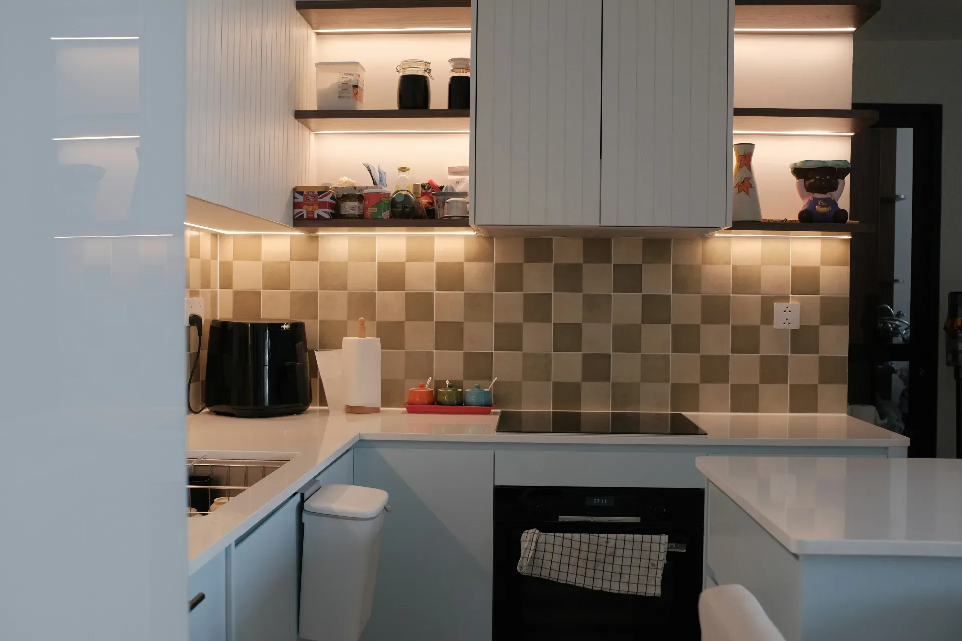 A kitchen with a stove top oven next to a sink