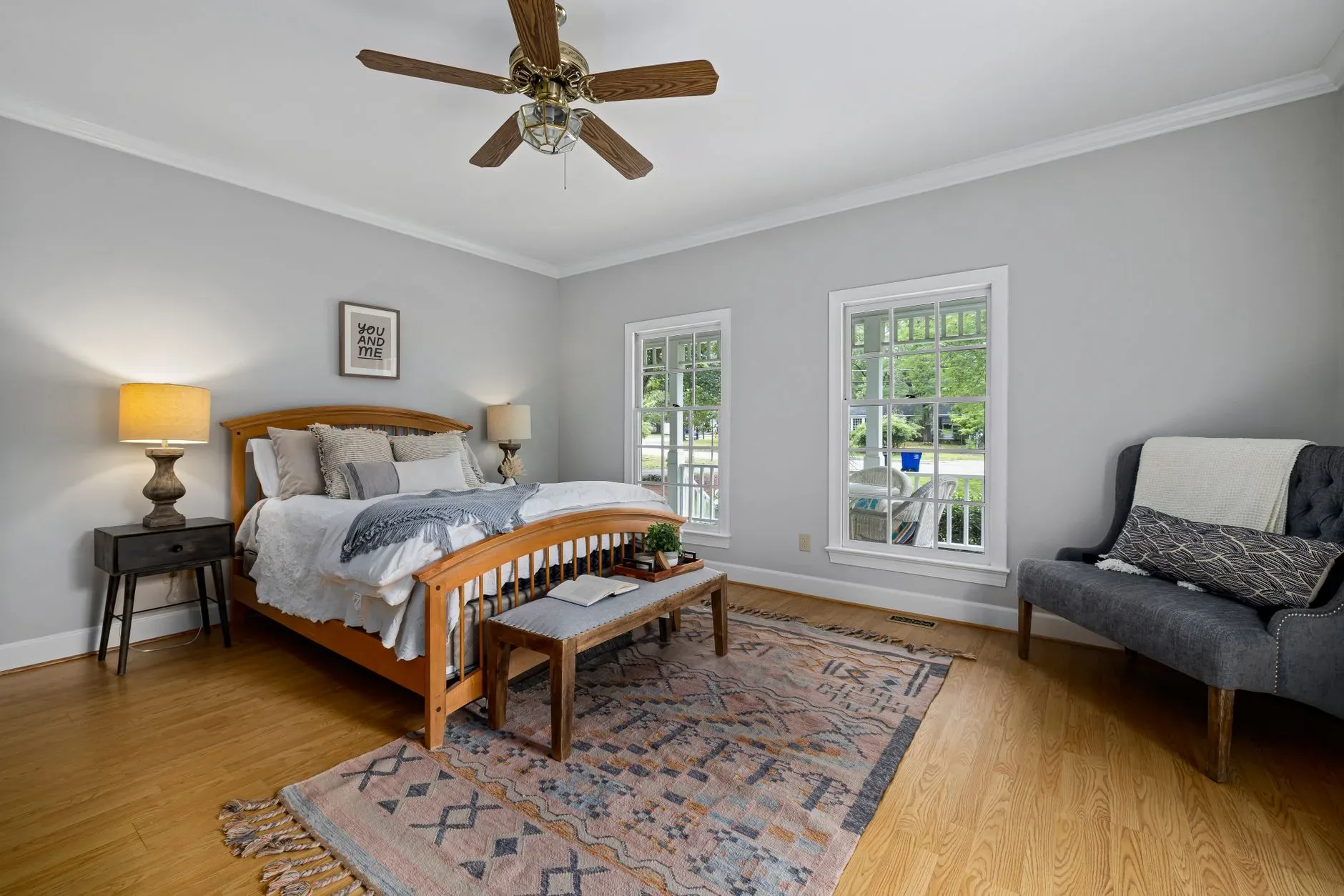A well-decorated bedroom with elegant furniture, natural light, and cozy ambience.