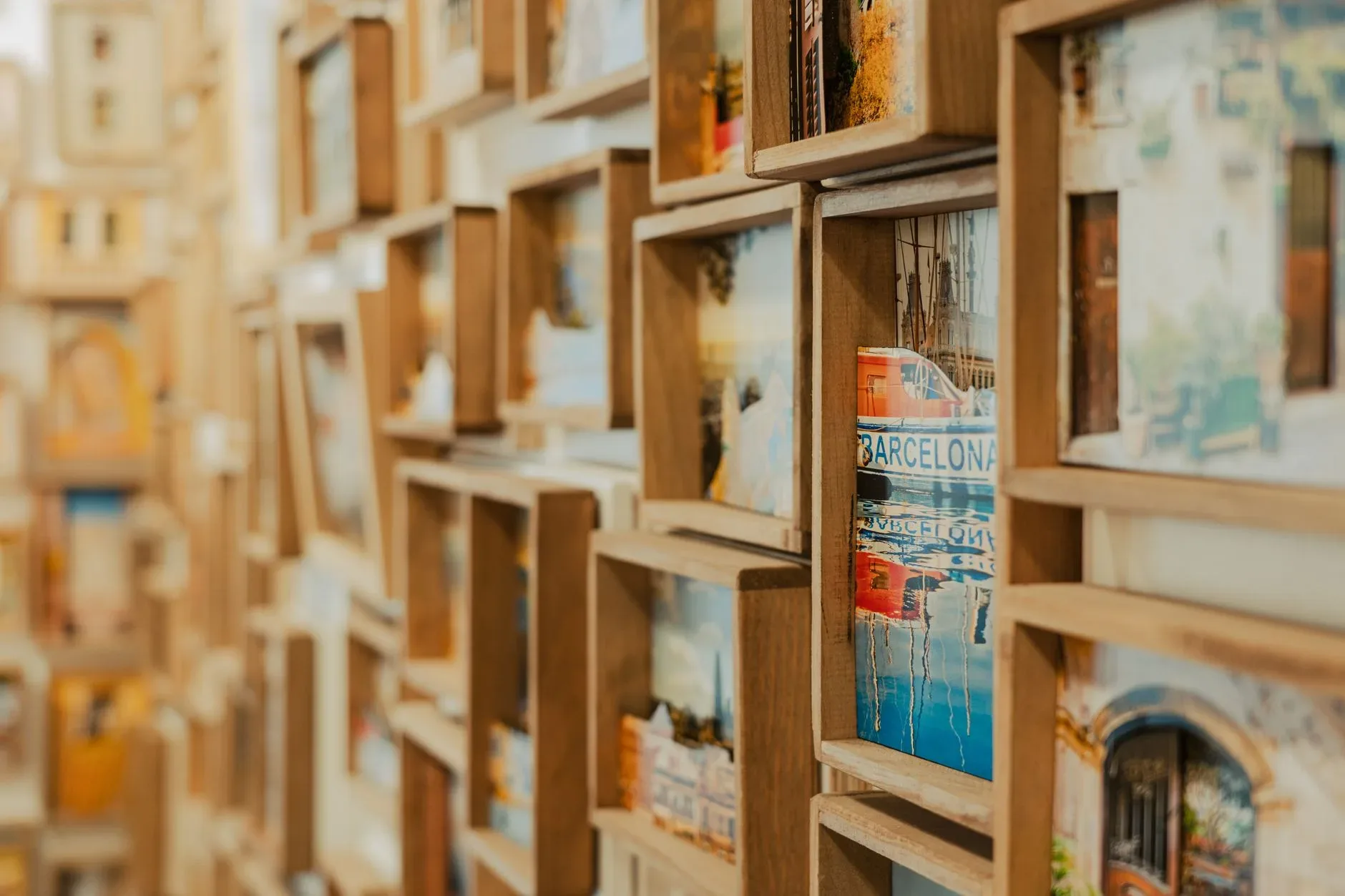 Artistic display of wooden frames showcasing Barcelona cityscapes in a retro style.