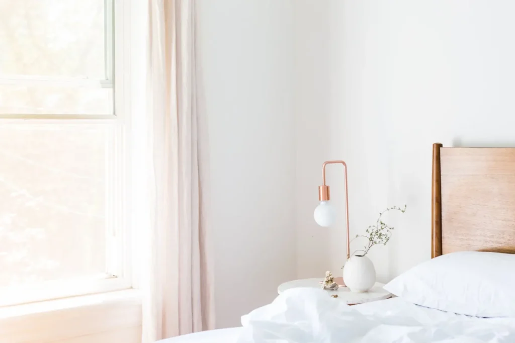 Bright minimalist bedroom with modern furniture and natural lighting.