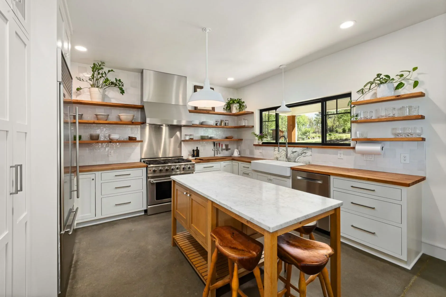 Bright modern kitchen with wooden accents, open shelves, and marble countertop.