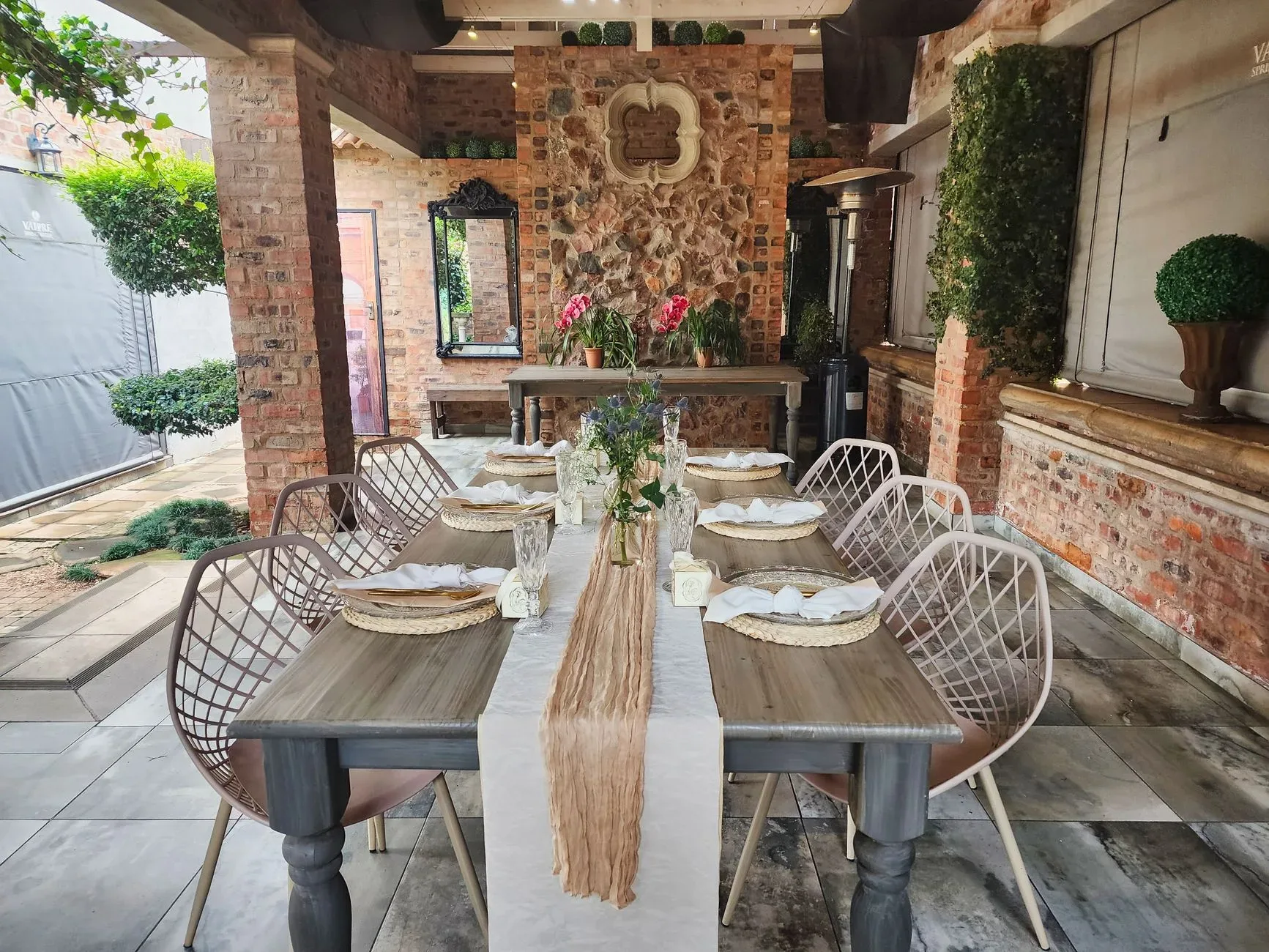 Charming outdoor dining area with rustic and brick decor, perfect for gatherings.