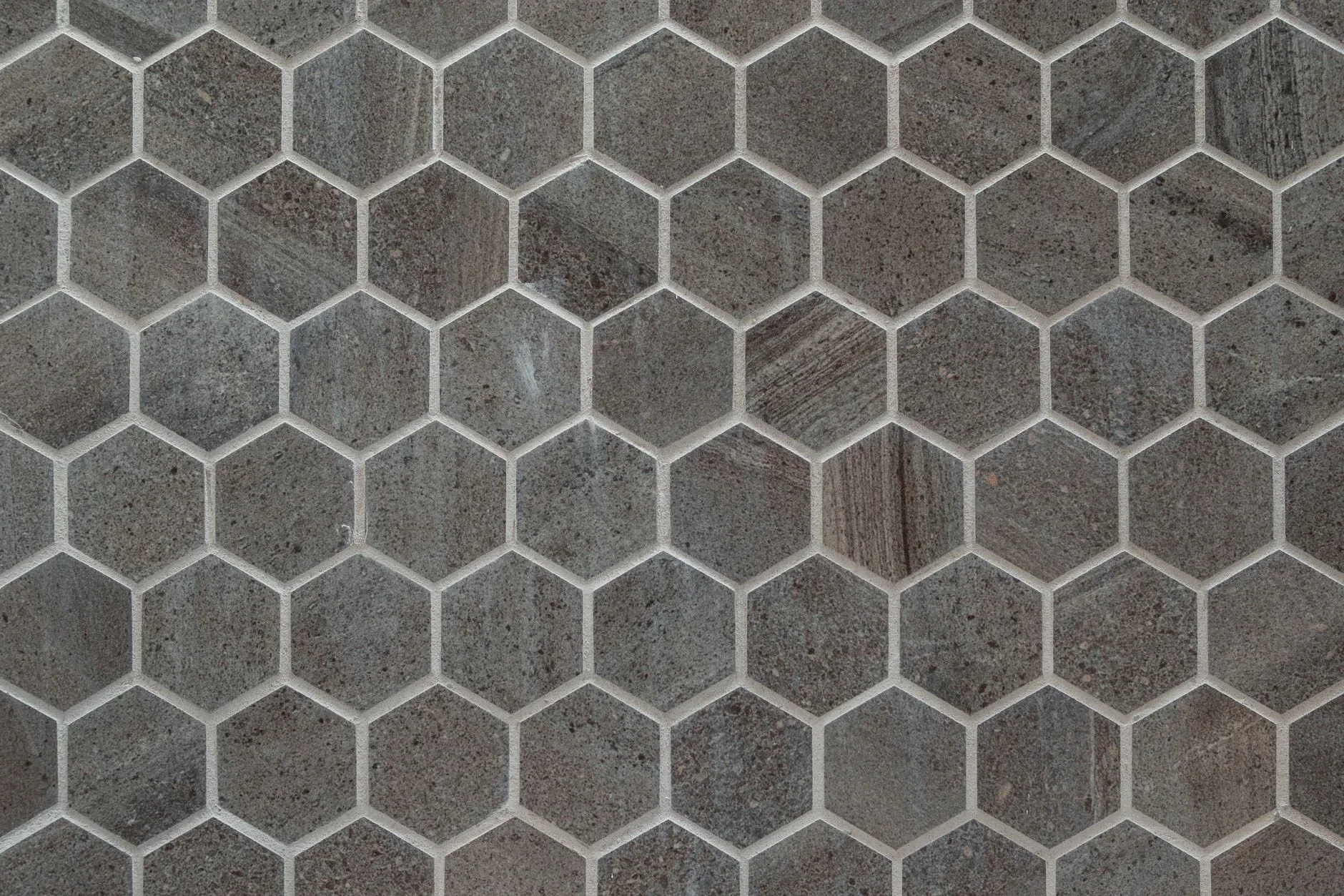 Close-up of gray hexagonal stone tiles creating a geometric pattern.