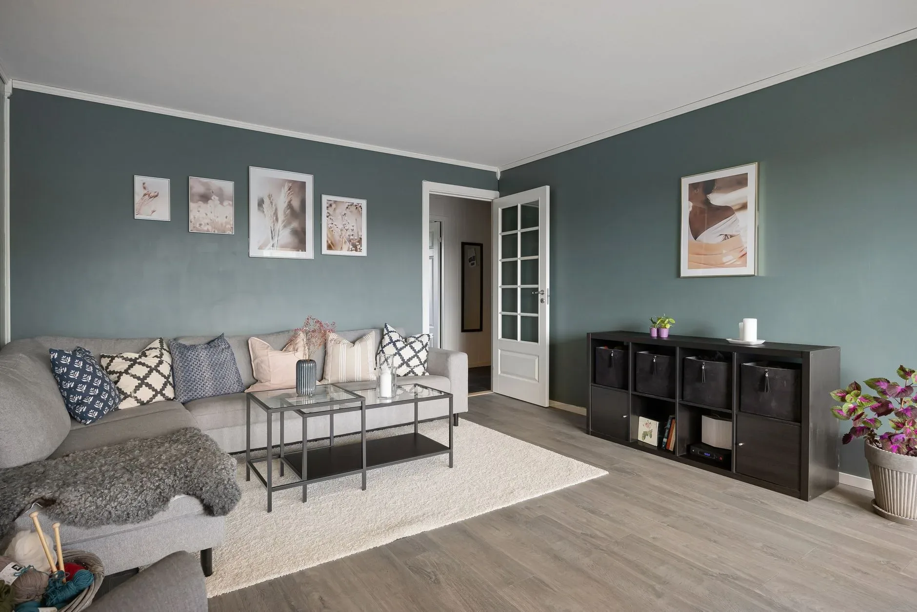 Contemporary living room featuring a cozy sectional sofa, coffee table, and decorative wall art.