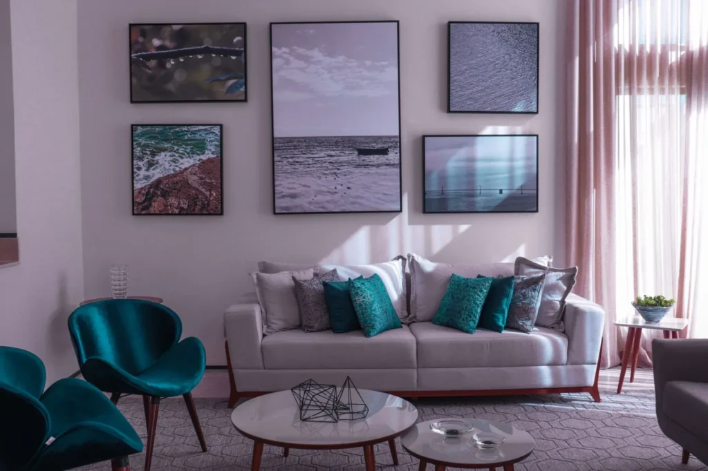 Contemporary living room featuring stylish decor, teal accents, and framed artwork.