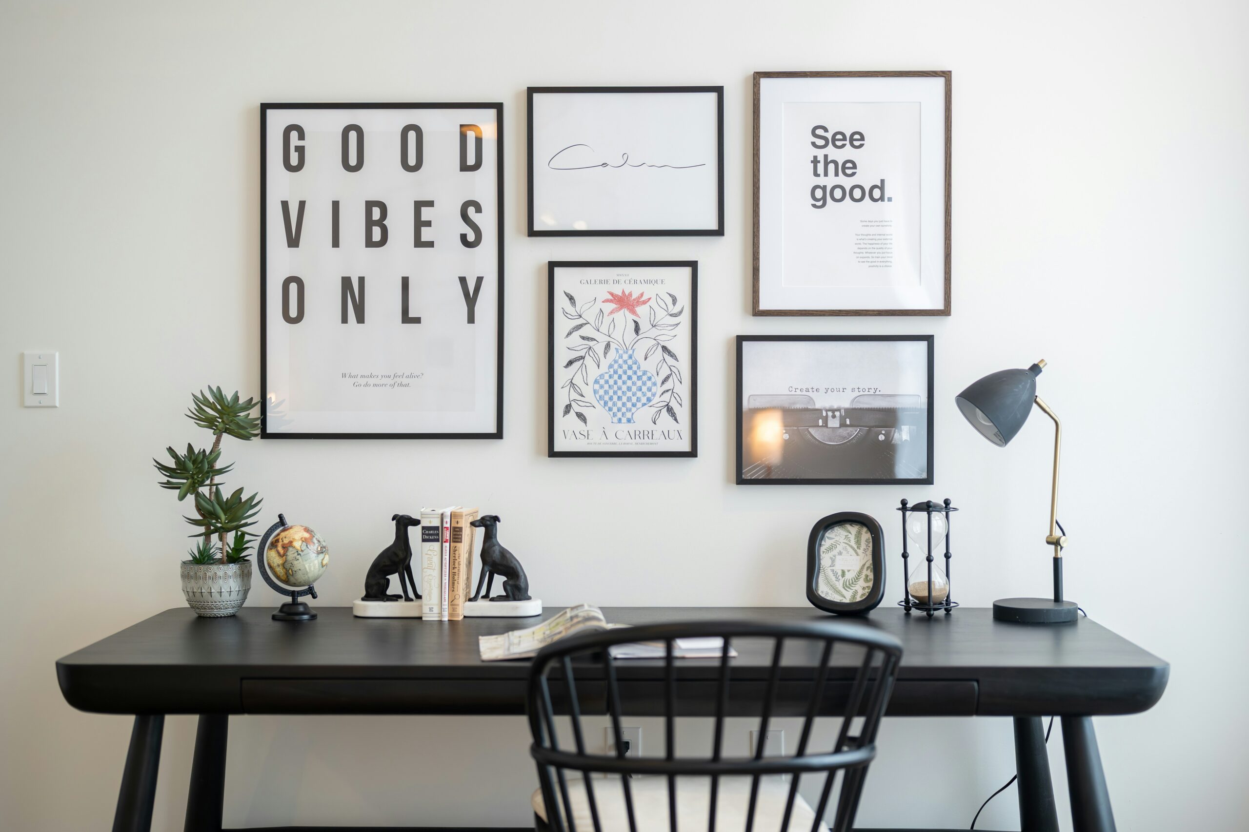 Desk with framed art and office supplies