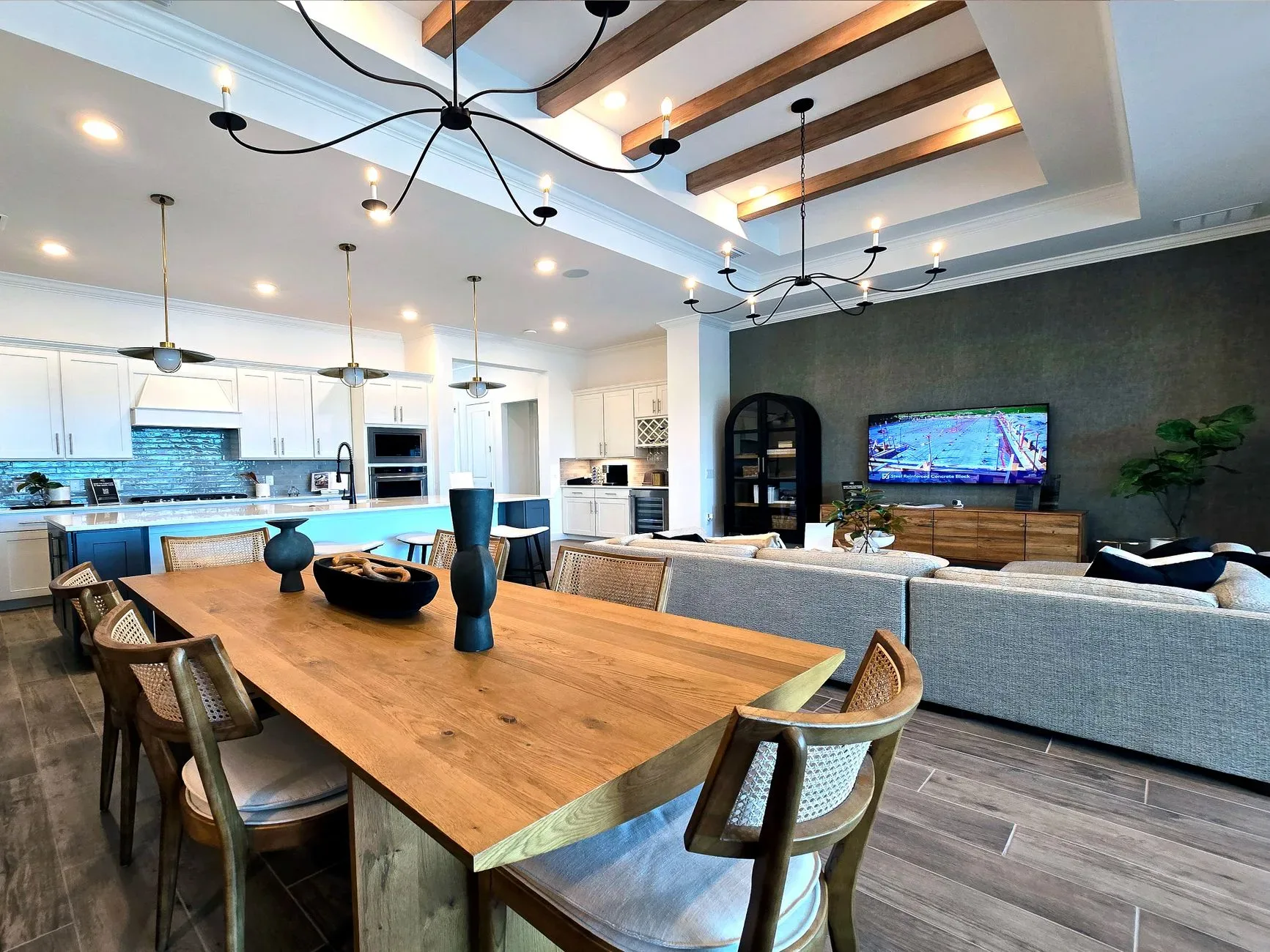 Elegant open-concept kitchen and living room with modern decor and ample natural lighting.