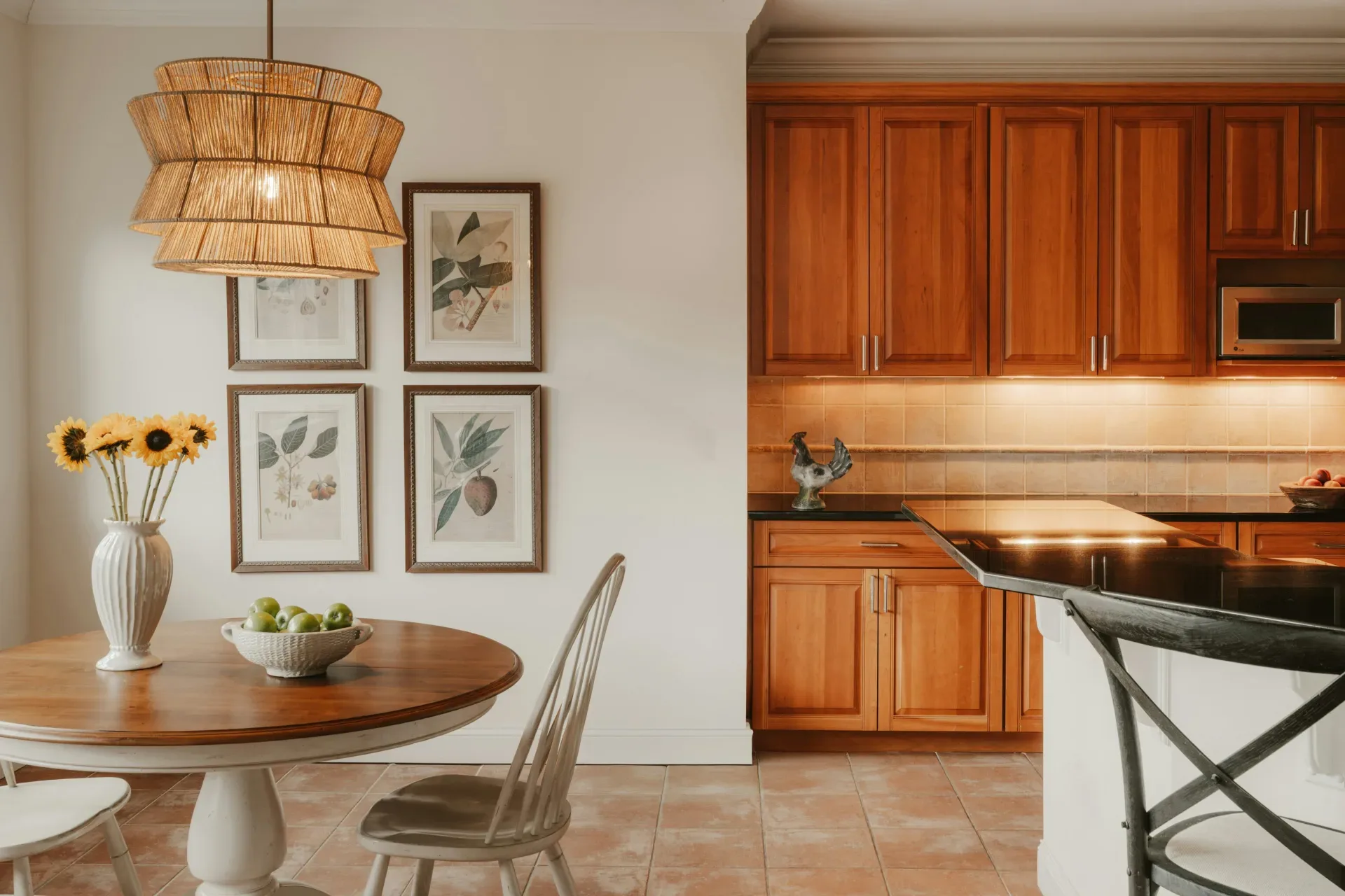 Kitchen and dining area with wooden cabinets and table.