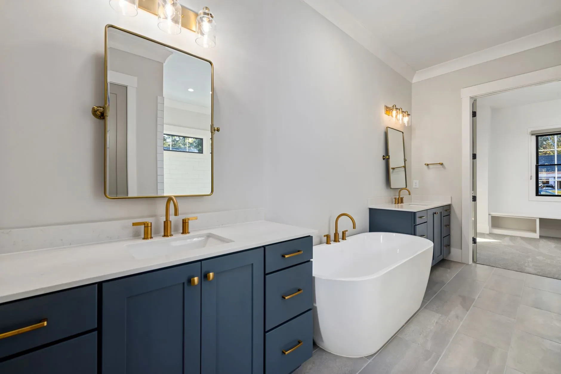 Luxurious bathroom featuring a freestanding tub, dual sinks, and modern fixtures. Perfect for interior design enthusiasts.