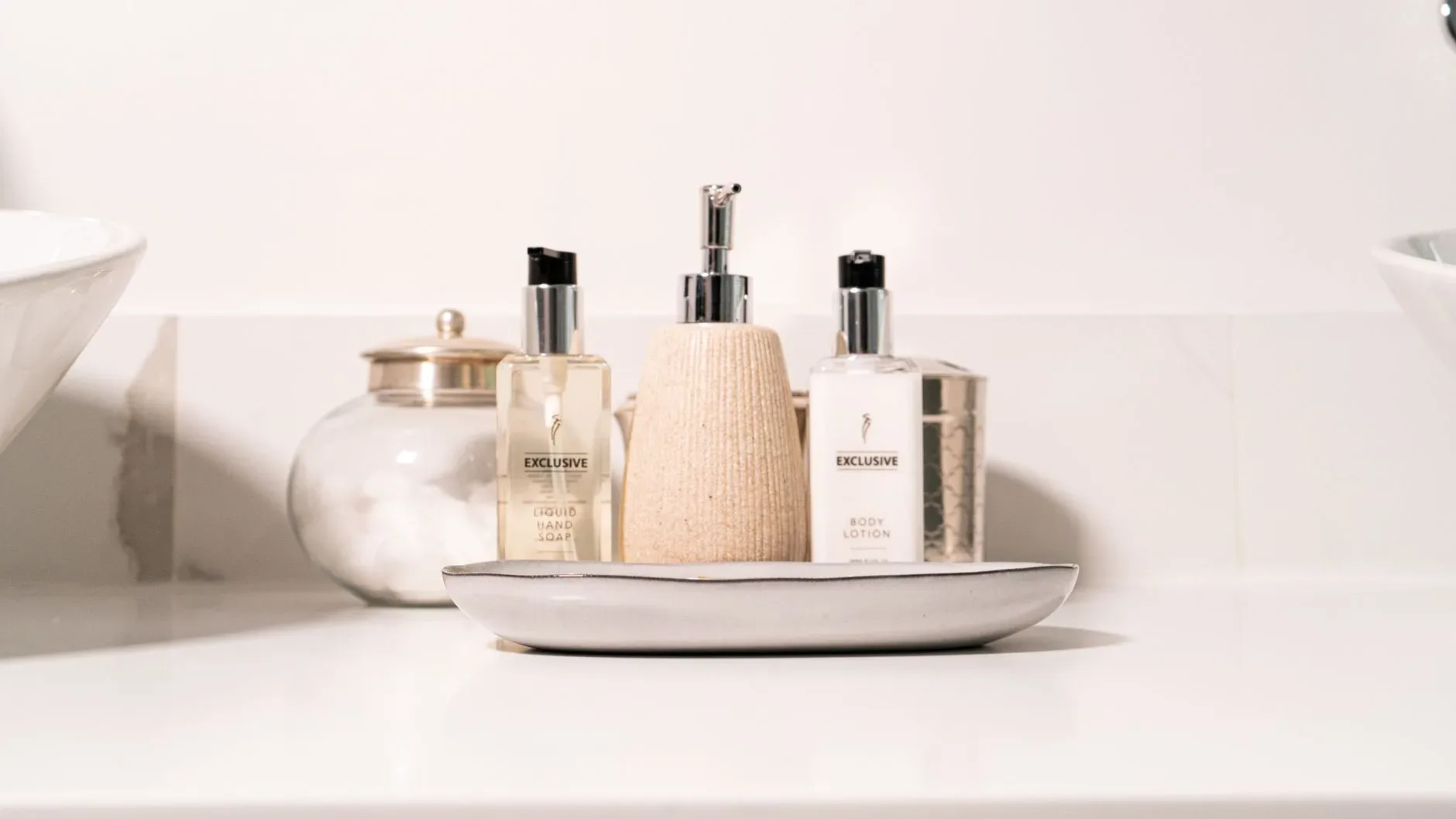 Minimalist bathroom setup with hand soap and lotion in a modern setting.