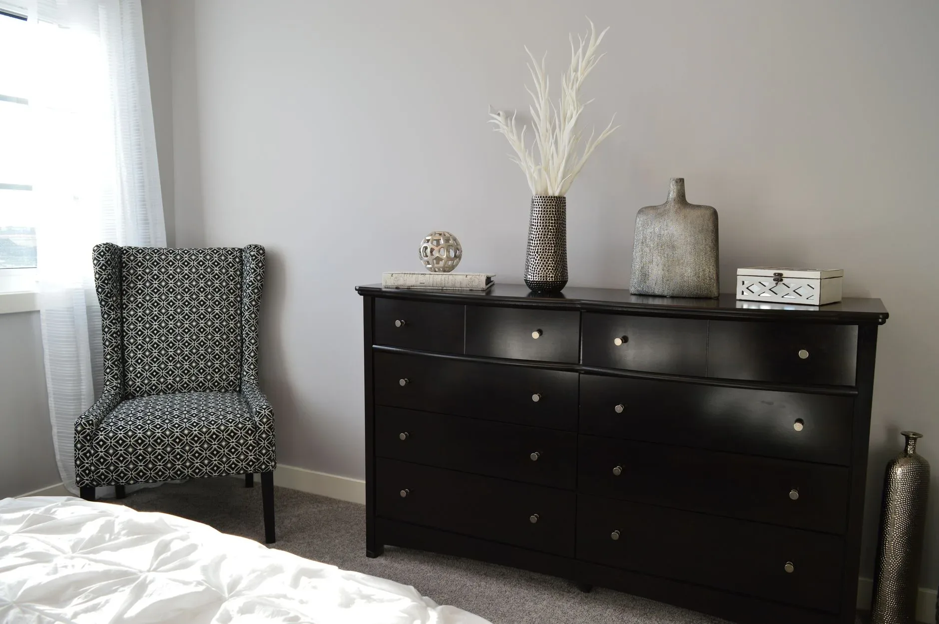 Sleek and stylish bedroom with modern black furniture and elegant decor.