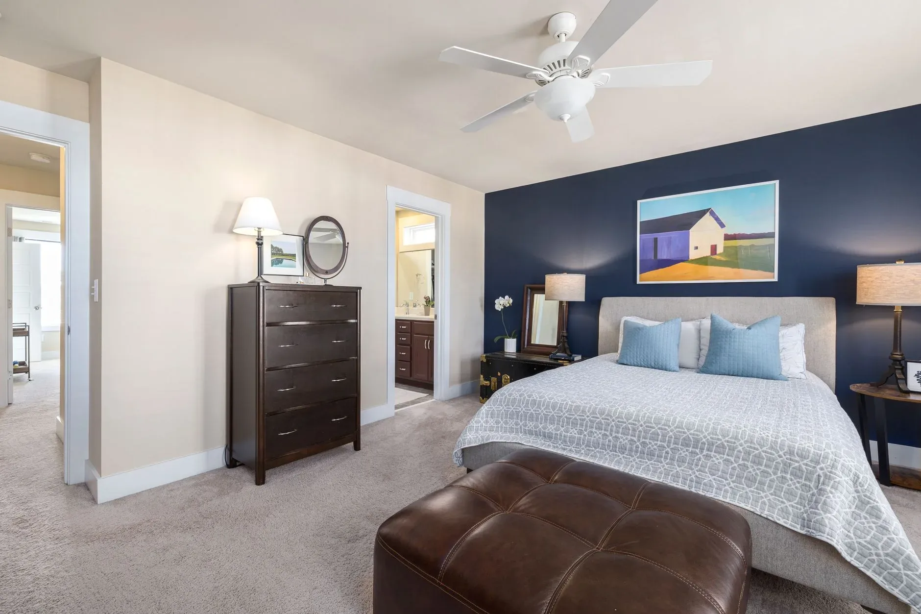 Spacious modern bedroom with stylish decor and natural light.