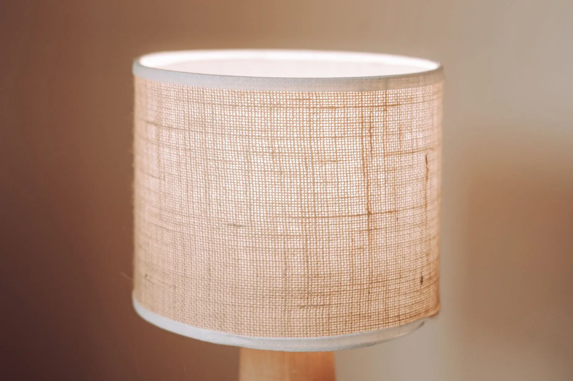 Textured table lamp with burlap shade, perfect for cozy interiors.