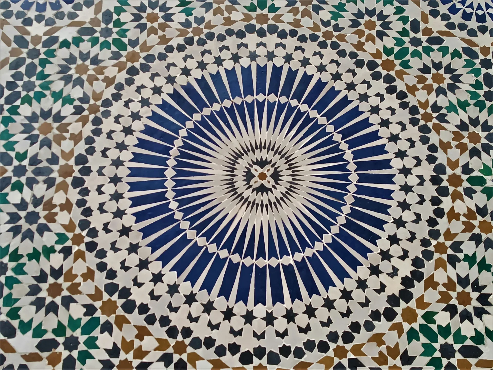 a blue and white tile with a circular design