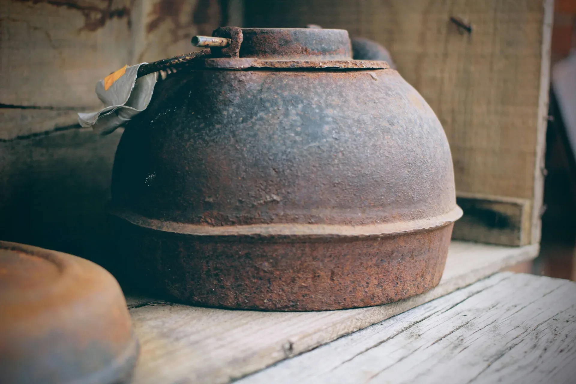 an old tea pot sitting on top of a wooden table