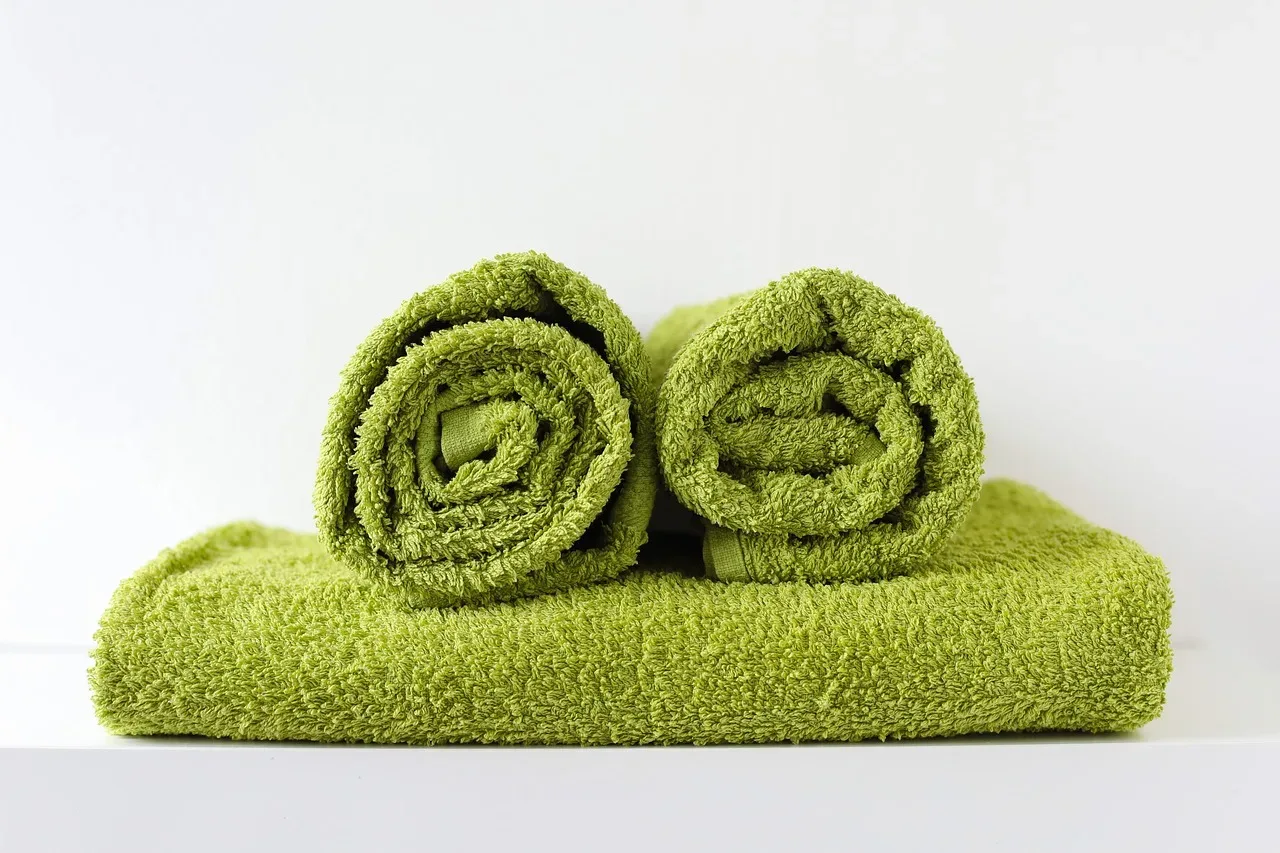 green linen towels bathroom rack folded